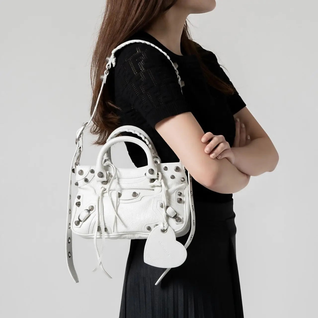 wearing BALENCIAGA NEO CAGOLE XS SHOULDER BAG WHITE 23FW 7515211VG9Y9104