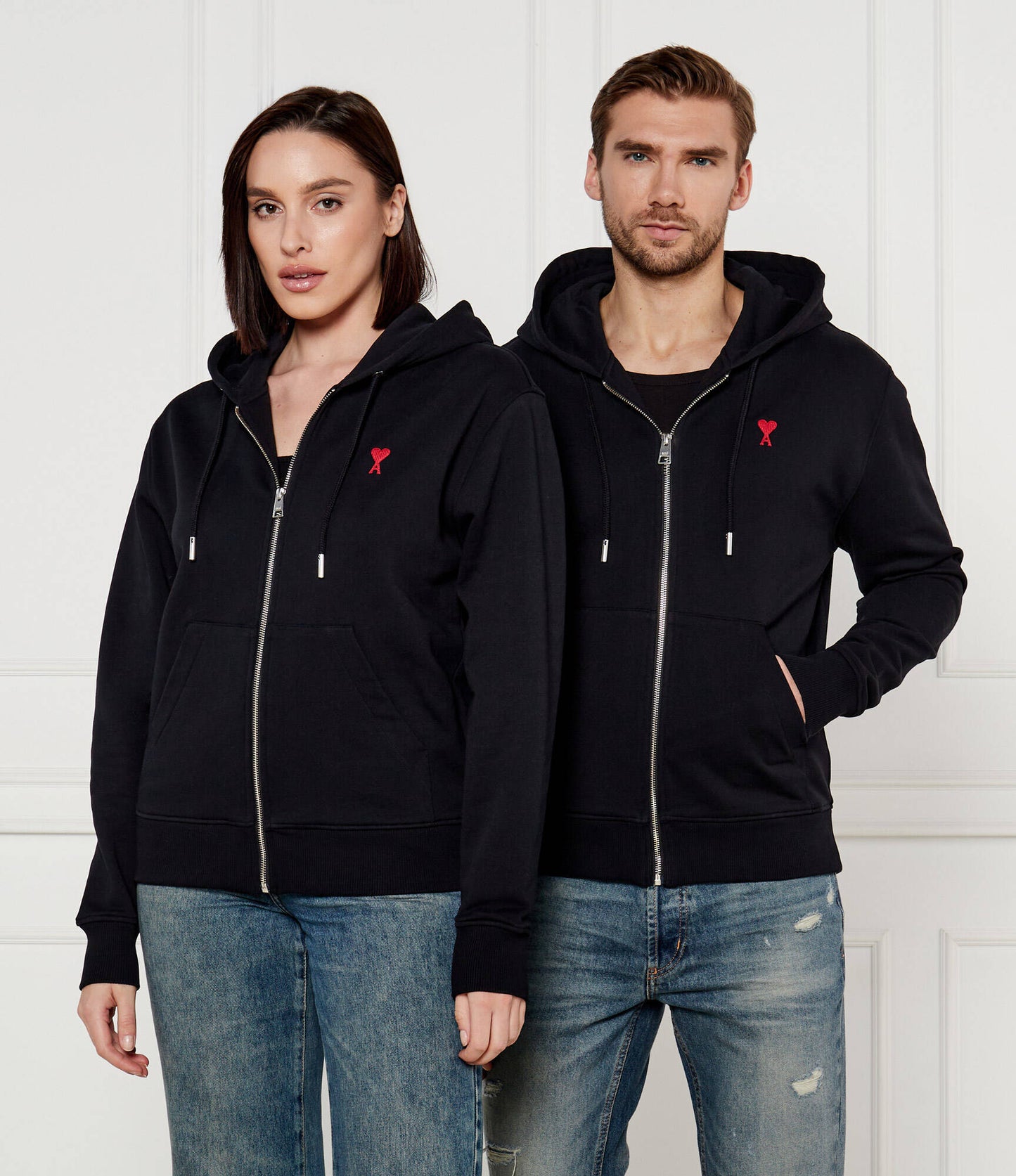Two people wearing Black Cotton Ami de Coeur Zipped Hoodie BFUSW435.730.001 against a white background