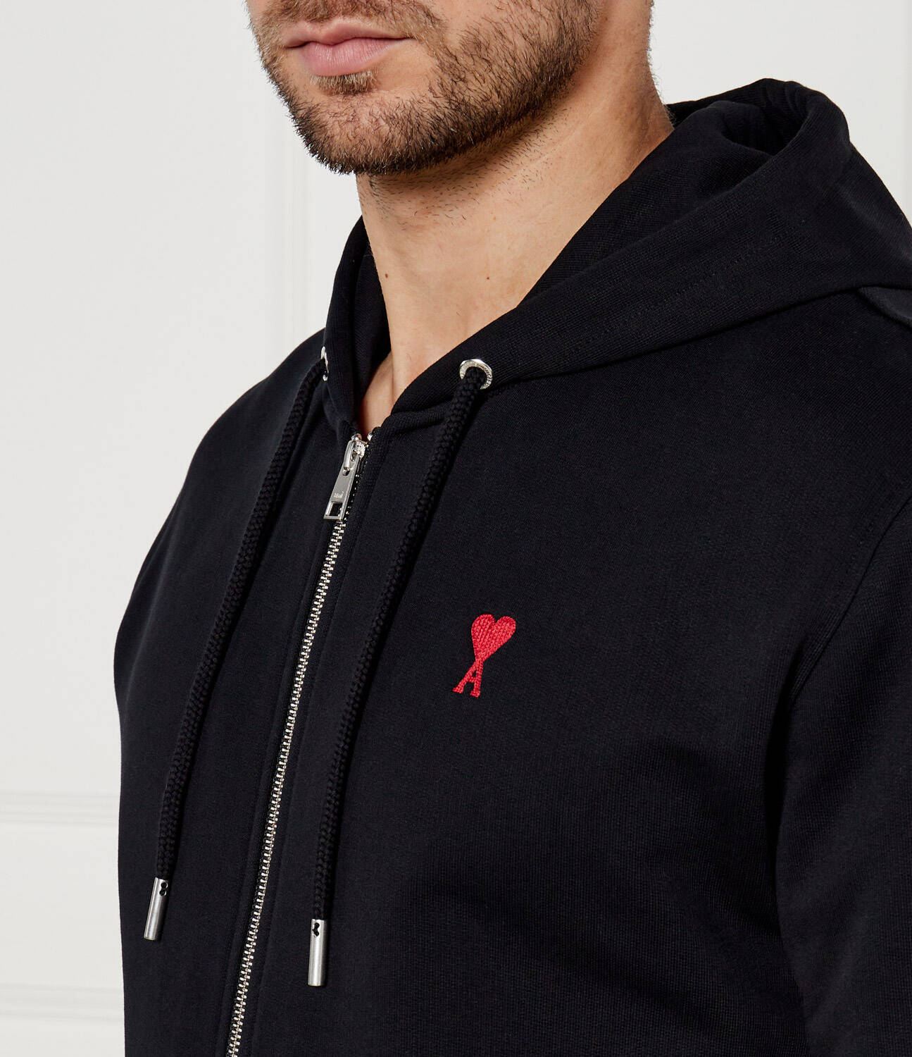 Black hoodie with a red heart design on a white background