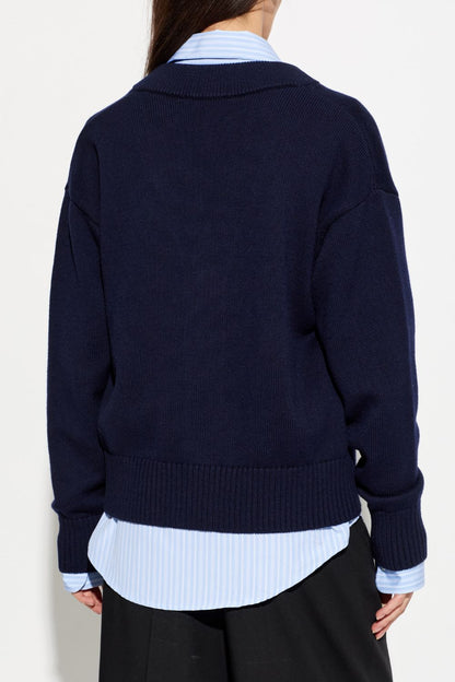 Person wearing a Ami Paris Blue Wool Ami De Coeur Cardigan UKC380.KN0156.A116 over a light blue shirt on a white background