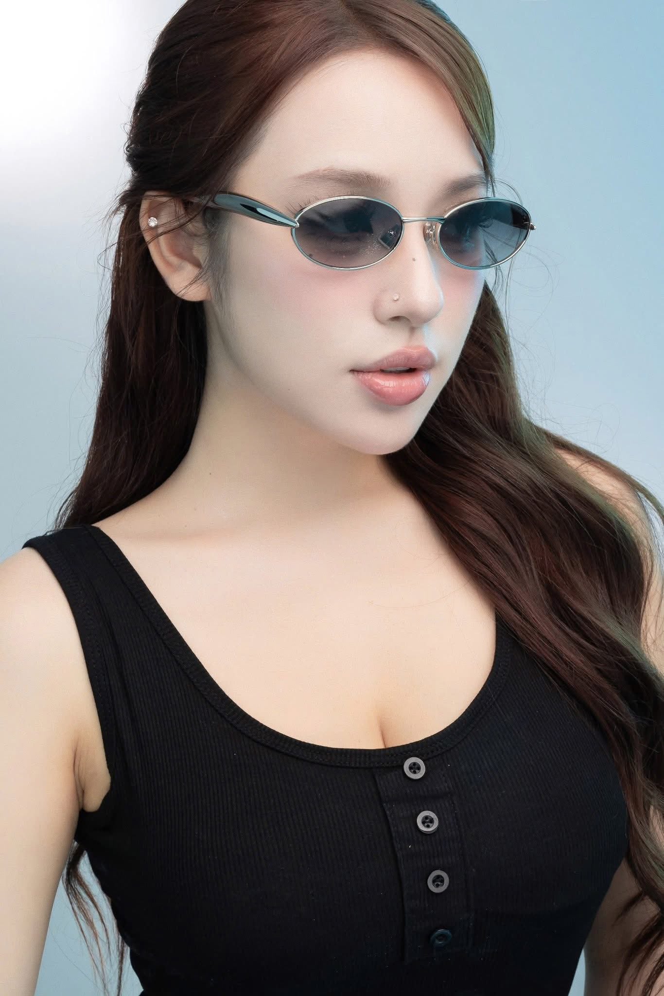 Woman wearing Bottega Veneta BV1386S 007 Silver Sunglasses with a plain background