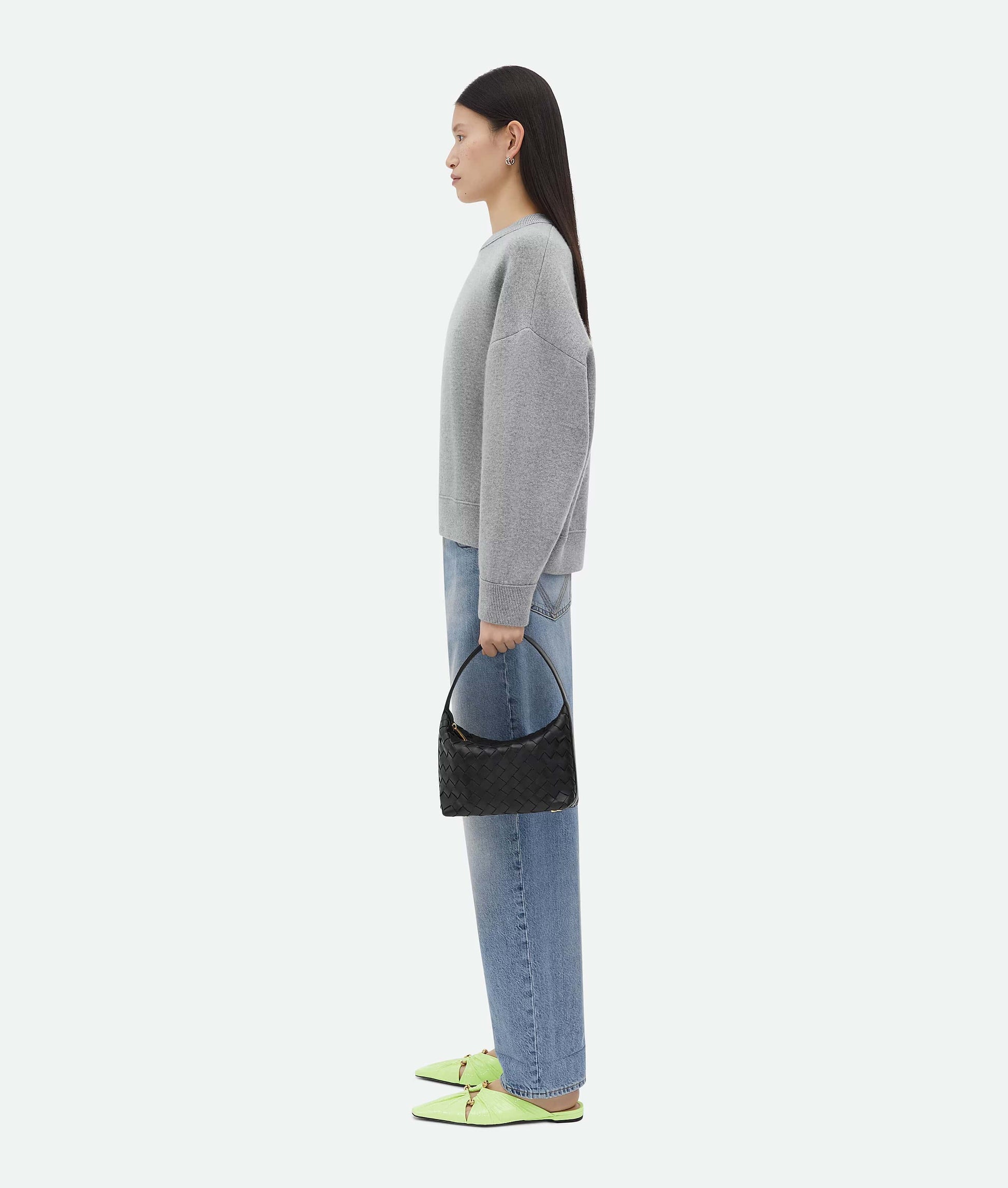 Woman holding a Bottega Veneta Mini Wallace Black 754443V3IV18425 on a white background