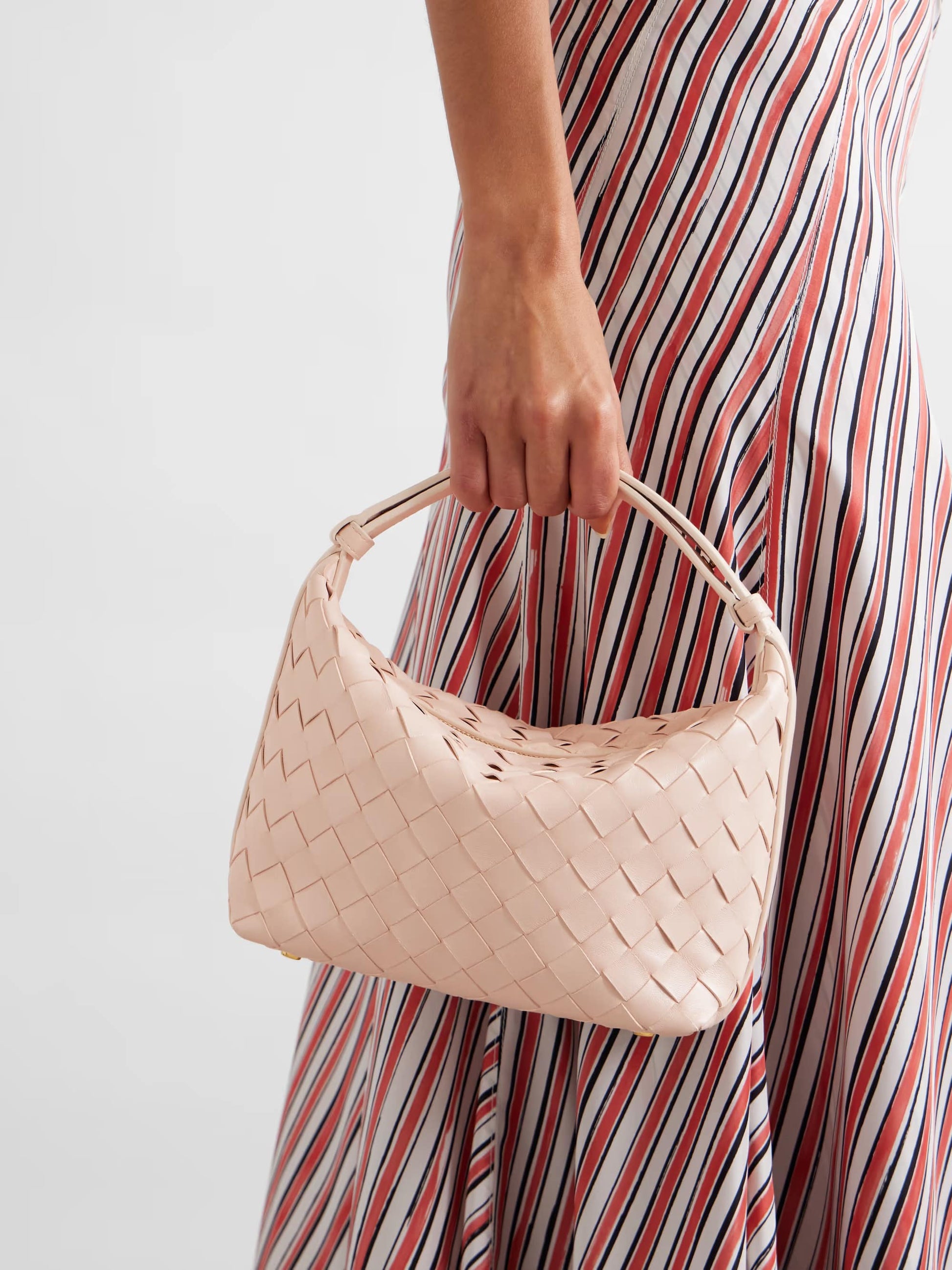 Women holding a Bottega Veneta Mini Wallace Pink 754443V3IV16805 against a neutral background