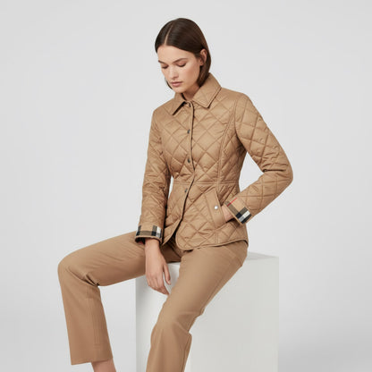 Woman wearing a Burberry Cawthorne Quilted Jacket Beige 81114601 and pants on a white background