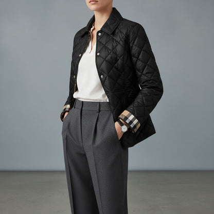 Person wearing a Burberry Cawthorne Quilted Jacket Black 81114591, white shirt, and gray pants against a gray background