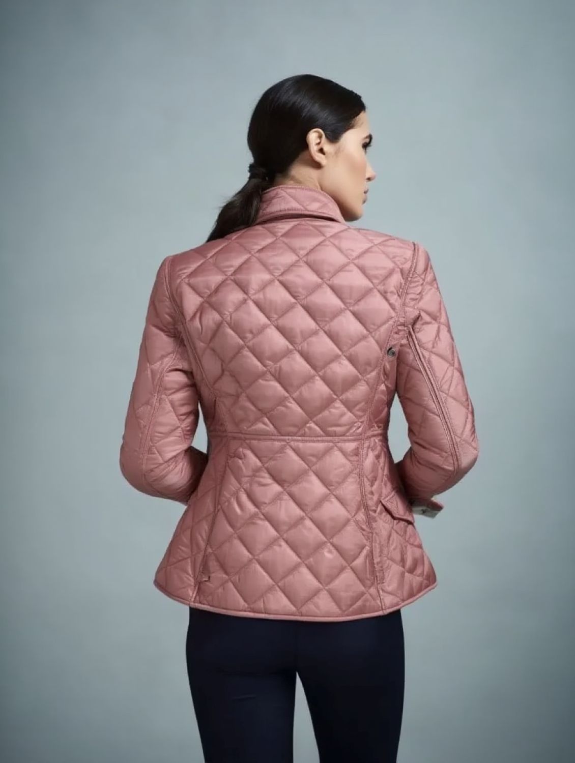 behind a Burberry Cawthorne Quilted Jacket Pink 81114581 on a gray background