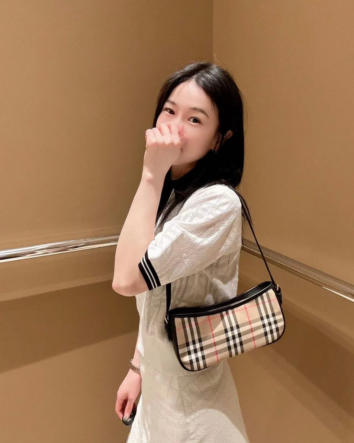 wearing BURBERRY VINTAGE CHECKED CAMEL AND BLACK SLING BAG 80788371 