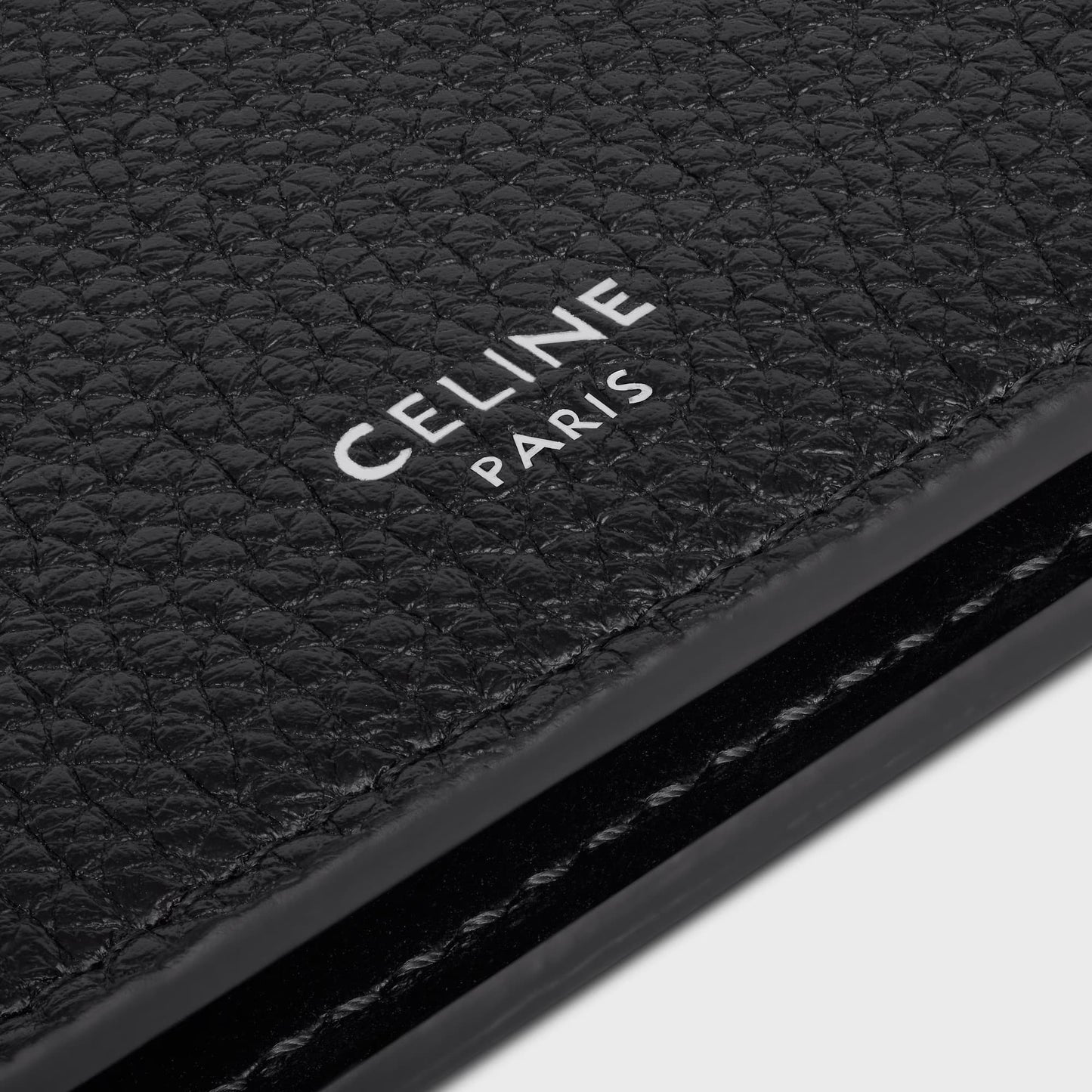 Close-up of a black leather product with 'CELINE PARIS' branding.