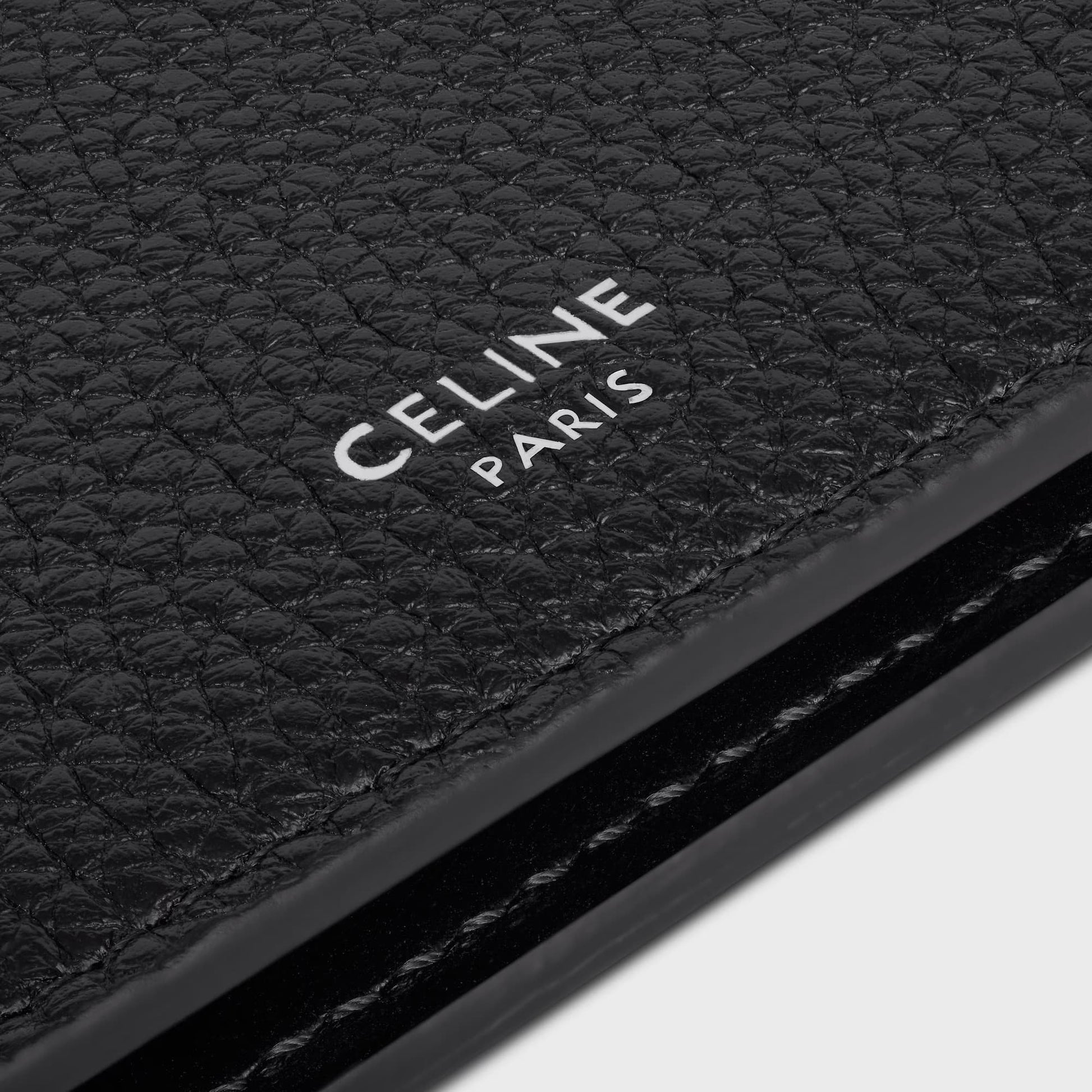 Close-up of a black leather product with 'CELINE PARIS' branding.
