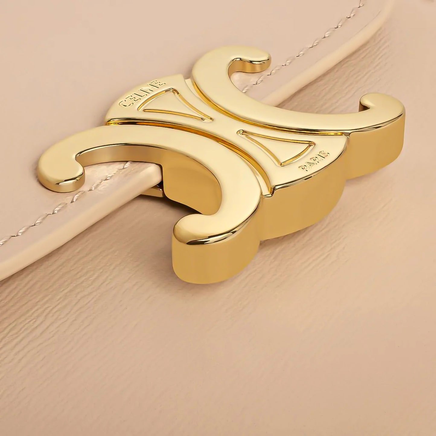 Gold Celine Small Flap Wallet Triomphe in Shiny Calfskin Oat Beige 10D783DPV.02EU clasp on a beige background