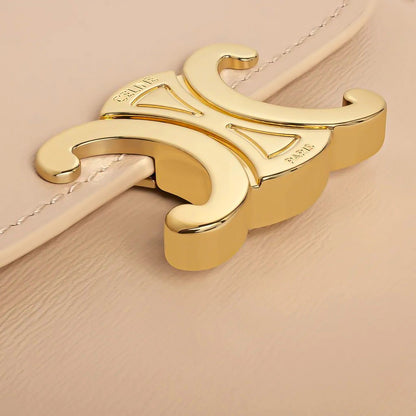 Gold Celine Small Flap Wallet Triomphe in Shiny Calfskin Oat Beige 10D783DPV.02EU clasp on a beige background