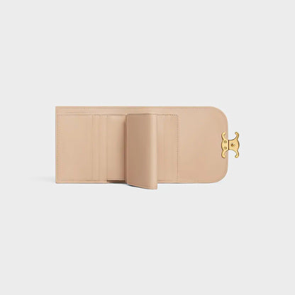 Celine Small Flap Wallet Triomphe in Shiny Calfskin Oat Beige 10D783DPV.02EU with gold clasp on a light gray background