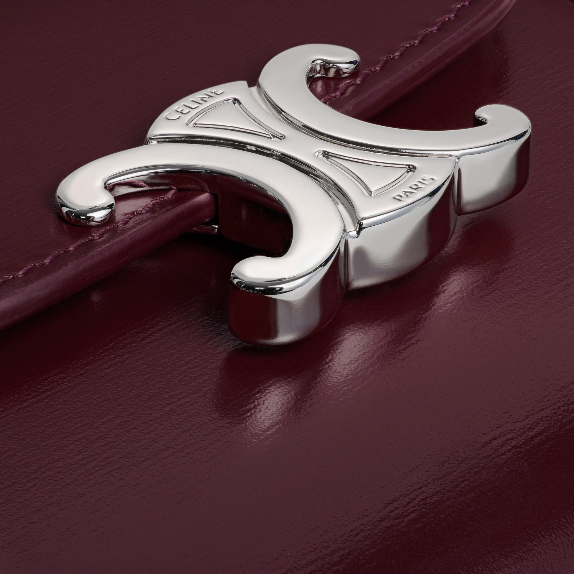 Close-up of a silver logo on a Celine Small Flap Wallet TRIOMPHE in Shiny Calfskin Deep Burgundy / Silver 10D783DPV.28DC