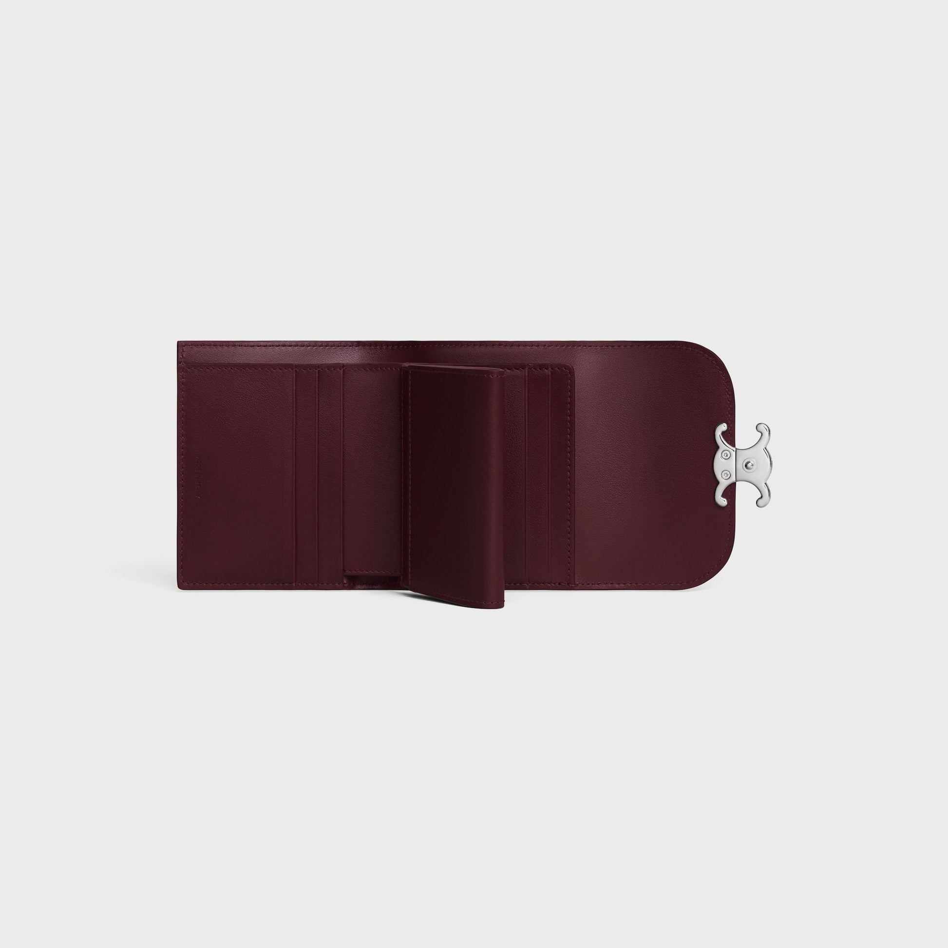 Open Celine Small Flap Wallet TRIOMPHE in Shiny Calfskin Deep Burgundy / Silver 10D783DPV.28DC with a silver clasp on a light gray background