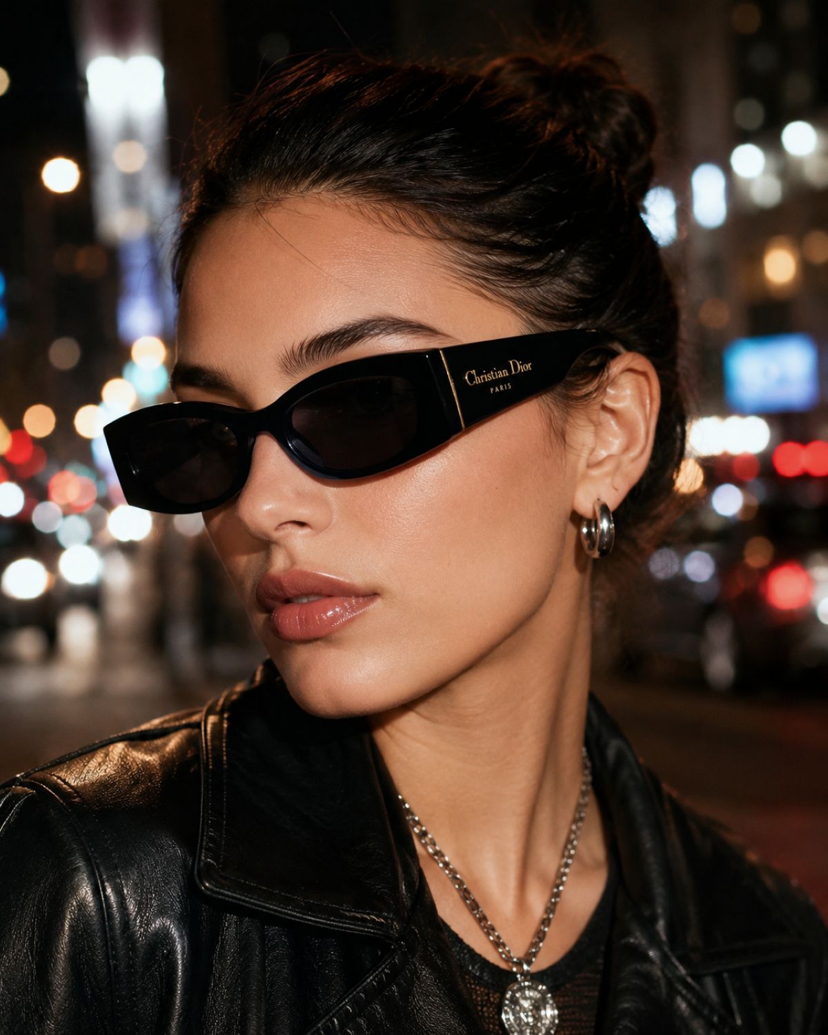Woman wearing Dior DiorOmbre S1F 10A0 Cat-Eye Sunglasses with a blurred city street background