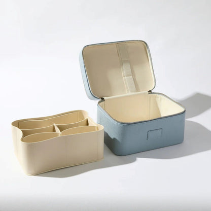 Open Étoile Duo Vanity Case Rodin Blue Limited Edition, one beige with compartments and one blue, on a light gray background.