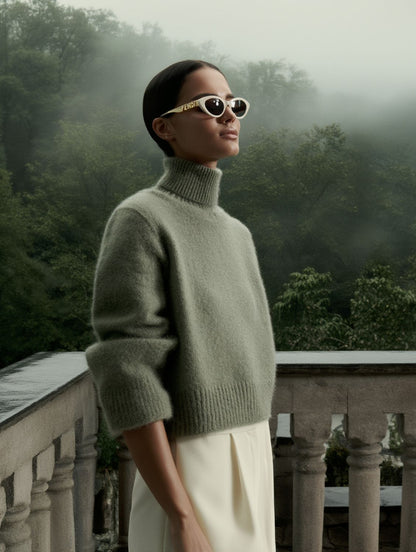 Women wearing a green sweater and Fendi FE40202I 25E — FendiGraphy Cat-Eye Sunglasses with a misty forest background