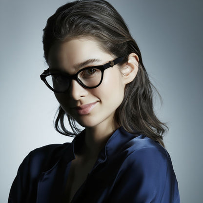 Woman wearing Fendi FE50134I-001 FF Diamonds Black Eyeglasses and a blue shirt against a gray background