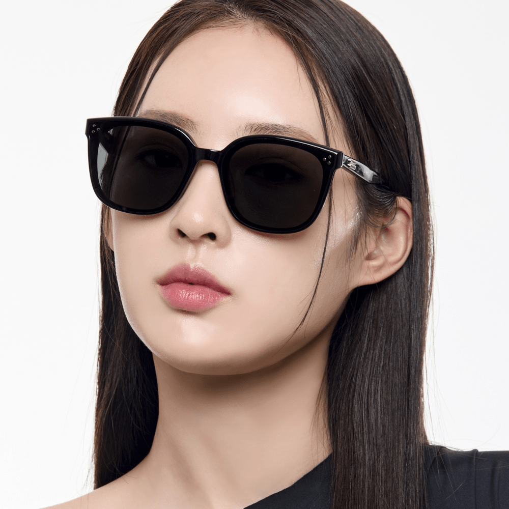 Woman wearing GENTLE MONSTER BY 01 with black tops in white background