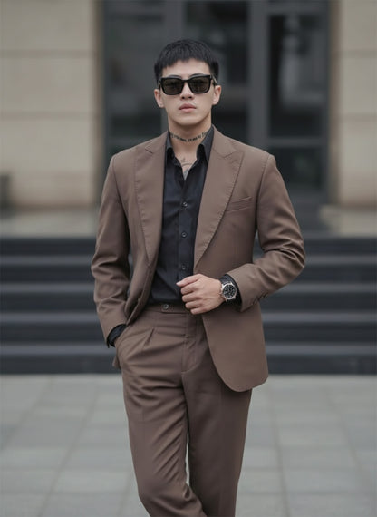 Man wearing a brown suit and Gentle Monster Daze 01 standing outdoors.