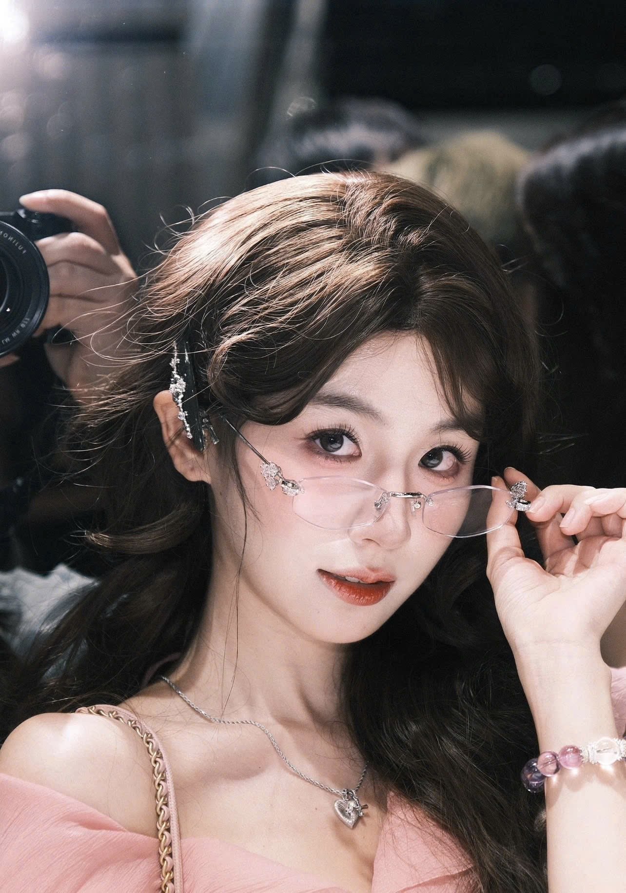 Woman adjusting Gentle Monster Glitz 02 with a blurred background