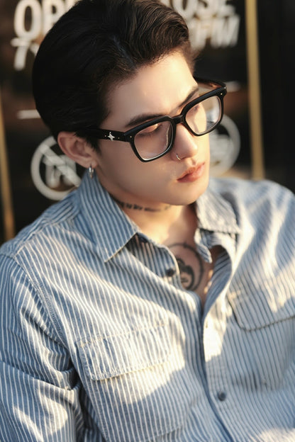 Person wearing Gentle Monster - GM Alto 01 and a striped shirt with a blurred background