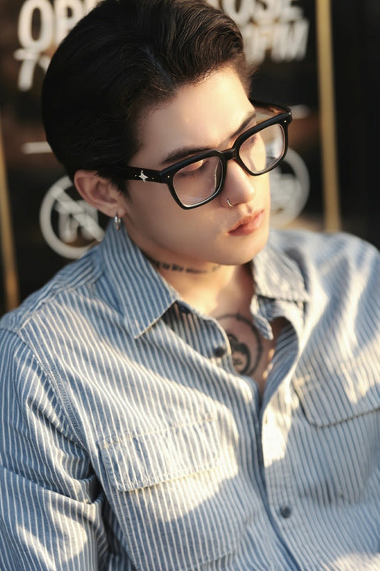 Person wearing Gentle Monster - GM Alto 01 and a striped shirt with a blurred background