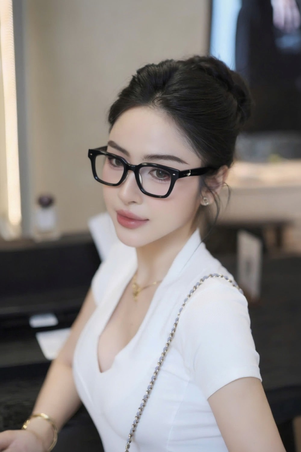 Woman wearing Gentle Monster - GM Alto 01 and a white top in an indoor setting