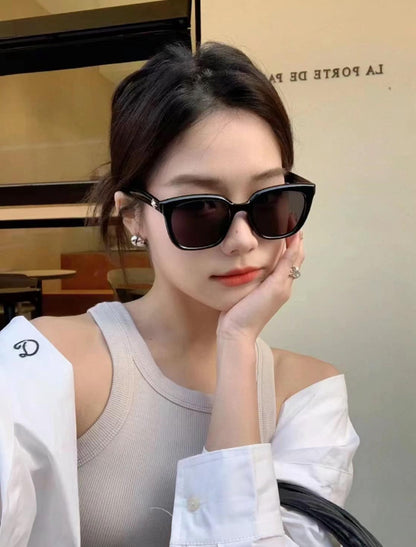 Woman wearing GENTLE MONSTER GM BILLY (01) with a blurred background
