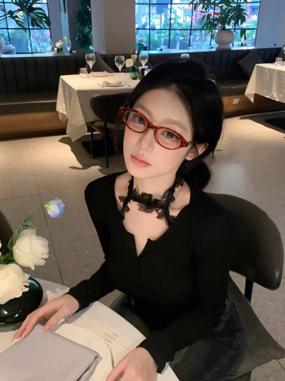 Woman wearing Gentle Monster - GM Corori T4 sitting at a restaurant table with a blurred background