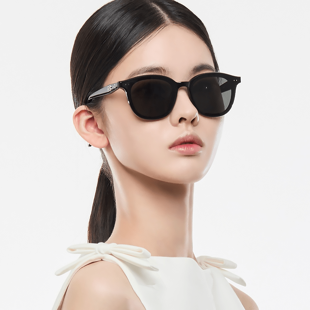 Woman wearing black Gentle Monster (GM) Jude 01 with a plain background