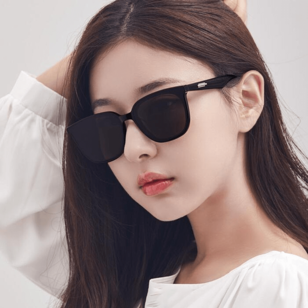 Woman wearing Gentle Monster (GM) Lilit 01 with a neutral background
