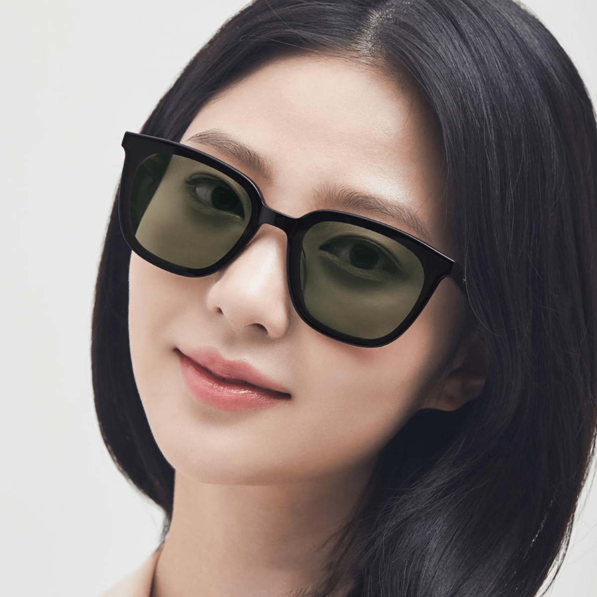 women wearing Gentle Monster - GM Lilit 01(K) with a plain background