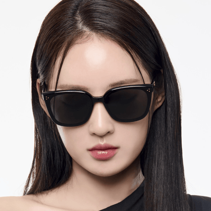 Woman wearing Gentle Monster (GM) Loloe 01 with a plain background