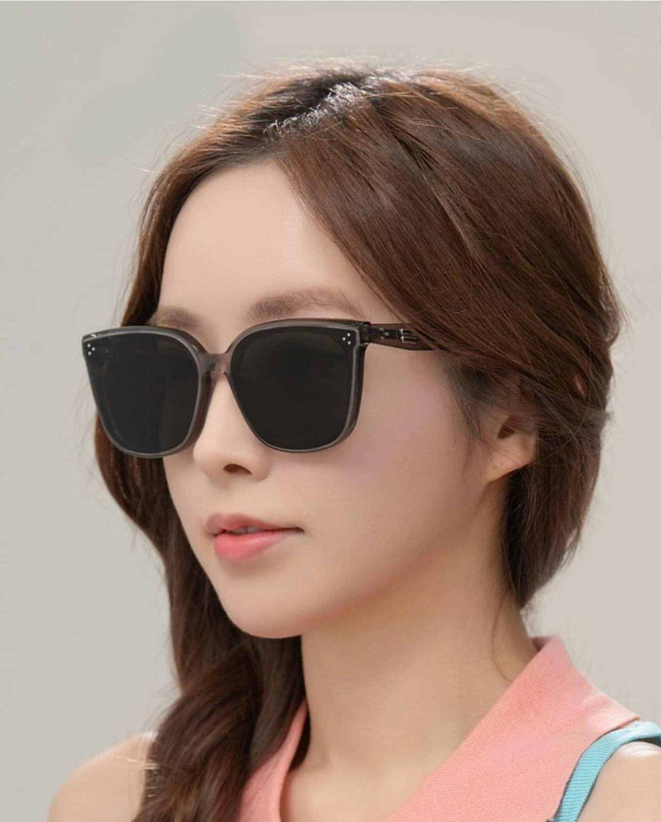 Woman wearing Gentle Monster (GM) Loloe BRC17 with a plain background