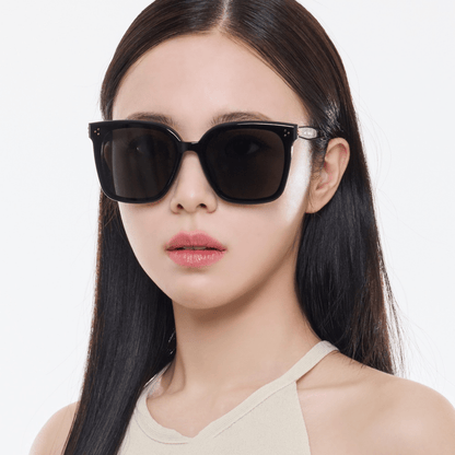 Woman wearing black Gentle Monster (GM) New Her 01 on a white background