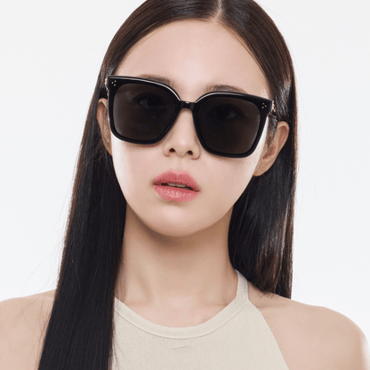 Woman wearing black Gentle Monster (GM) New Her 01 on a white background
