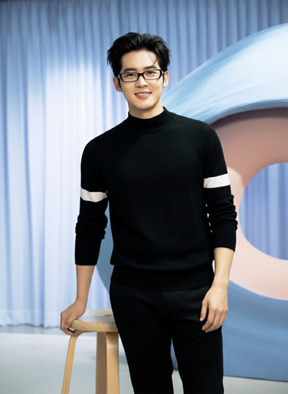 Man wearing a Gentle Monster Halo G18 in a black sweater with white stripes in a studio setting