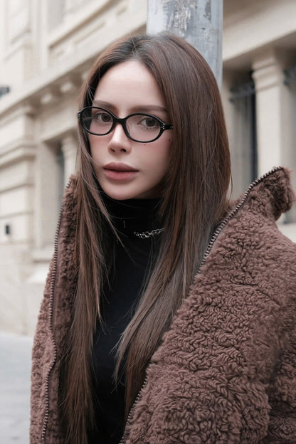Woman wearing Gentle Monster La Cha 01(C) Round Optical Glasses and a brown coat in an urban setting