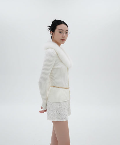 Woman wearing a Gentle Monster Origami 031  with white outfit with a fur collar against a white background