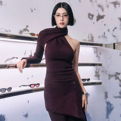 Woman wearing Gentle Monster Paranoyd 02(CM) Square Glasses in a burgundy dress standing in front of a display of sunglasses.