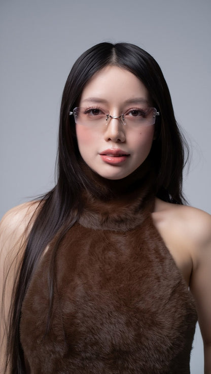 Woman wearing Gentle Monster Paranoyd 02(GM) Square Glasses and a brown top against a gray background