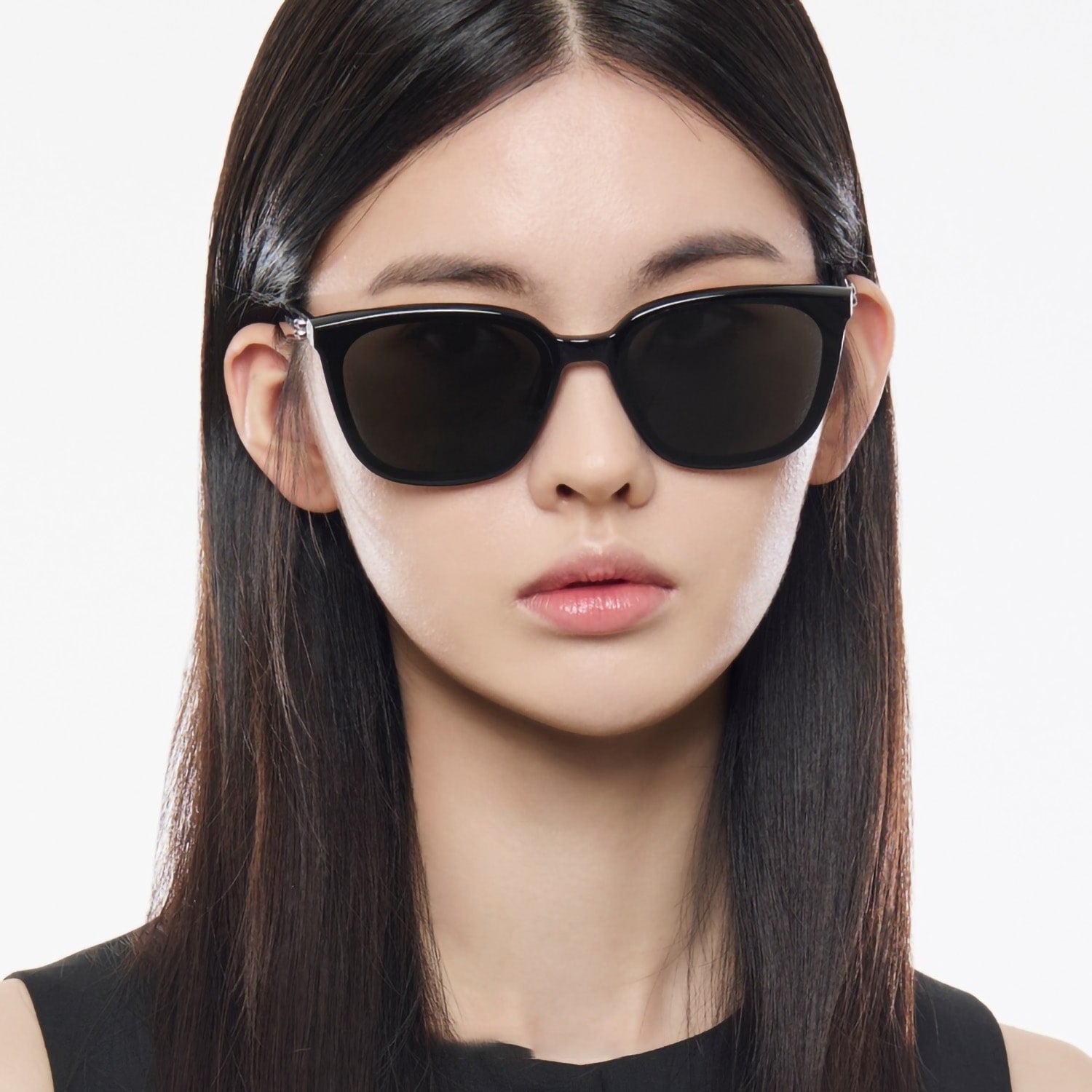 Woman wearing Gentle Monster Pino 01 Square Sunglasses with a plain background
