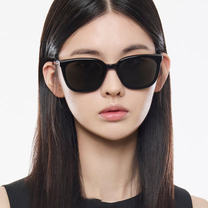 Woman wearing Gentle Monster Pino 01 Square Sunglasses with a plain background