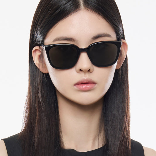 Woman wearing Gentle Monster Pino 01 Square Sunglasses with a plain background