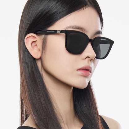 Woman wearing Gentle Monster Pino 01 Square Sunglasses with a neutral background