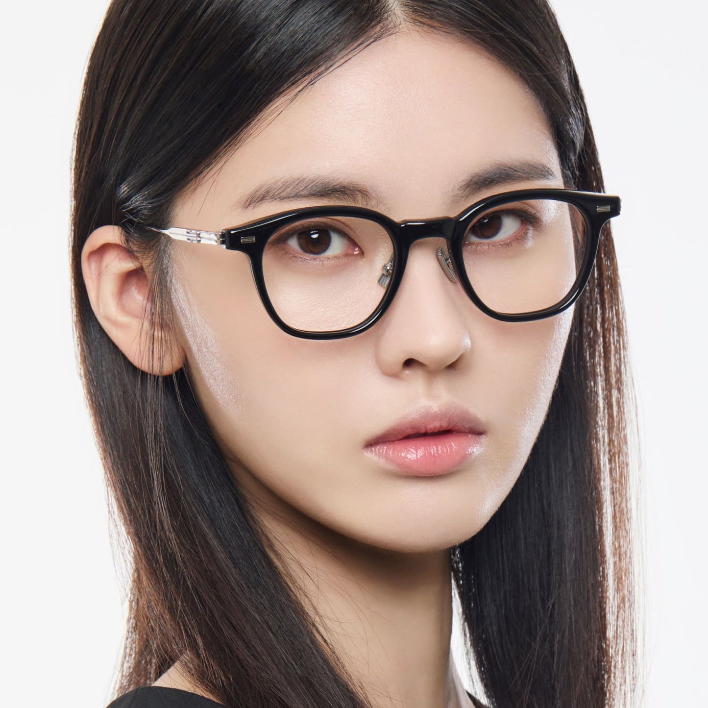 Close-up of a woman wearing Gentle Monster Rob 01 Square Optical Glasses with a plain background