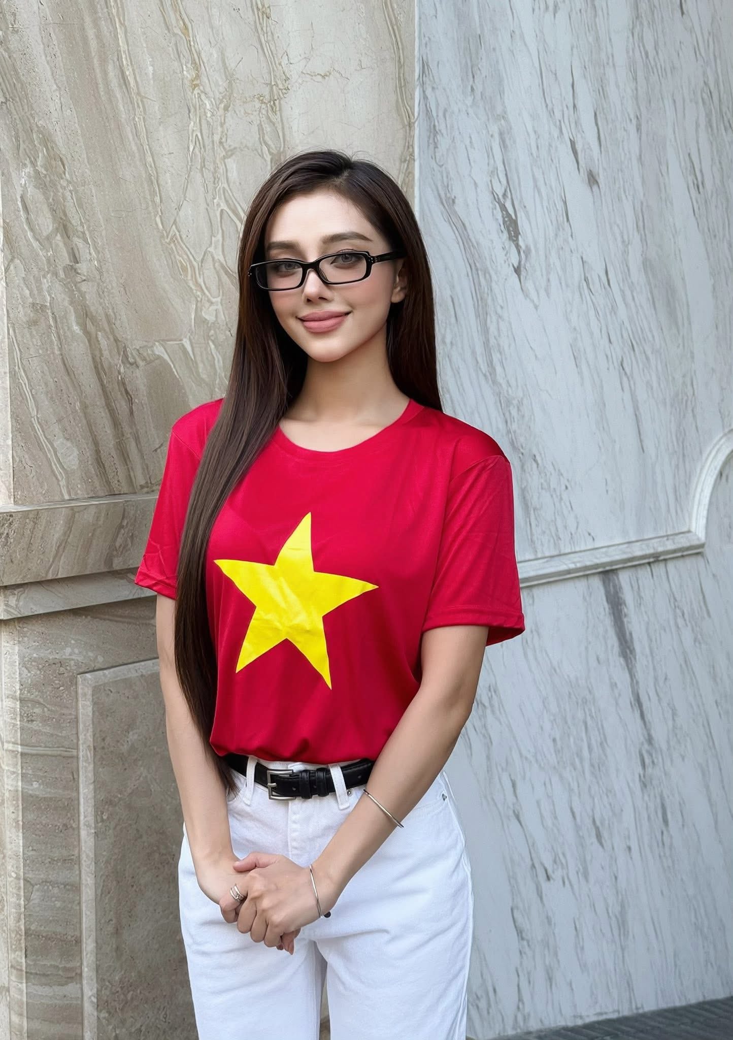 Woman wearing a vietnam logo t-shirt with Gentle Monster - GM Slyk 01 (Light Adaptive) against a marble wall.