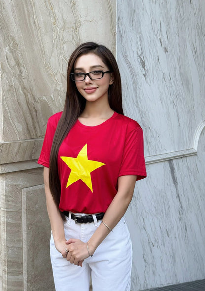 Woman wearing a vietnam logo t-shirt with Gentle Monster - GM Slyk 01 (Light Adaptive) against a marble wall.