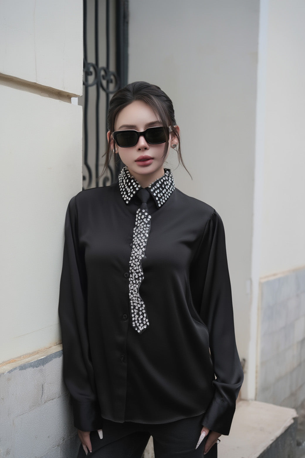 Person wearing a black blouse with a decorative collar & Gentle Monster Soho 01 standing against a light-colored wall.